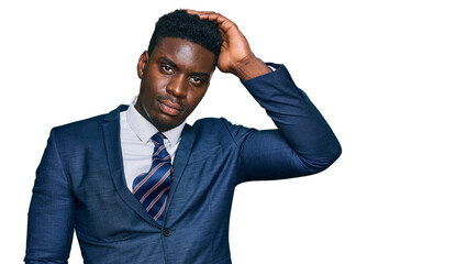 Handsome business black man wearing business suit and tie confuse and wonder about question. uncertain with doubt, thinking with hand on head. pensive concept.