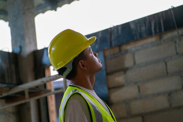 Foreman working in modern house building with notebook