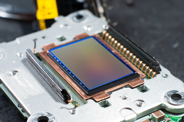 Replacing the camera matrix board in a photographic equipment repair service. Close-up...