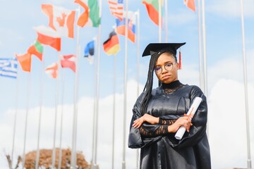 cheerful african american graduate student with diploma in her hand