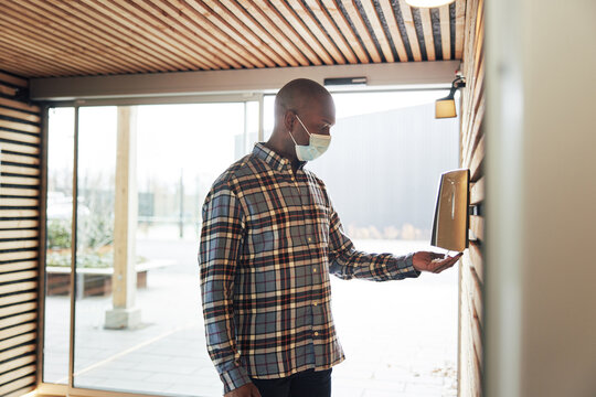 Businessman sanitizing his hands at work