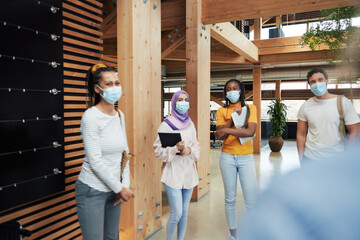 Diverse businesspeople wearing face masks at work