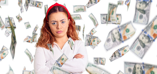 Young latin woman wearing waitress apron skeptic and nervous, disapproving expression on face with...