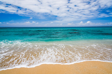 Ocean waves, beach, and blue sky in the Kenting National Park of Pingtung, Taiwan.