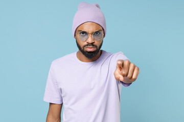 Young strict serious unshaven student black african man 20s in violet t-shirt hat glasses point...