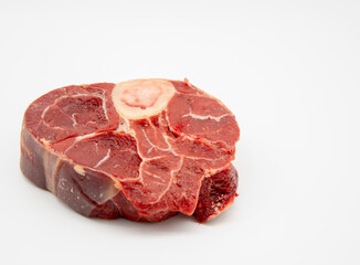 Obraz premium A piece of raw meat with a bone on a white background.