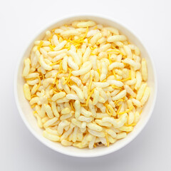 Close-Up of Crunchy Lemon Bhel in a white ceramic bowl made with Puffed Rice small besan sev. Indian spicy snacks (Namkeen), Top View
