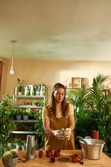 Young girl standing at the table and working