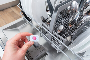 A tablet of a detergent for washing dishes in dishwashing machine