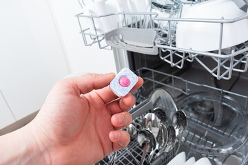 A tablet of a detergent for washing dishes in dishwashing machine