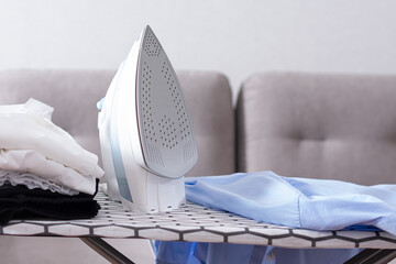 Steaming iron on ironing board