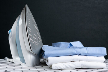 Steaming iron on ironing board