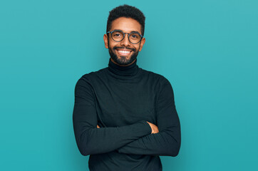 Young african american man wearing casual clothes happy face smiling with crossed arms looking at the camera. positive person.