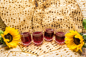 Pesah celebration concept - Jewish Passover holiday. Unleavened bread food – matzoh, glasses with...
