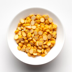 Macro Close-up of Organic Bengal Gram (Cicer arietinum) or split yellow chana dal inside a ceramic white bowl. Top view 