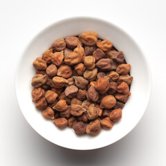 macro Close-up of Organic chana or chickpea (Cicer arietinum) or whole white Bengal gram dal inside a ceramic white bowl. Top view 