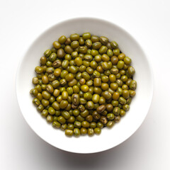 macro Close-up of Organic green Gram (Vigna radiata) or whole green moong dal inside a ceramic white bowl. Top view 
