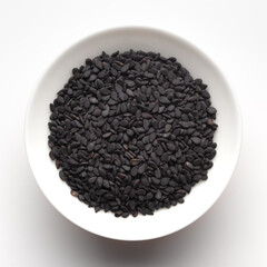Macro Close up of Organic Black Sesame seeds(Sesamum indicum) or Black Til with shell inside a white ceramic bowl
