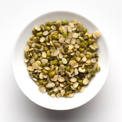 macro Close-up of Organic green Gram (Vigna radiata) or spilt green moong dal unpolished inside a ceramic white bowl. Top view 
