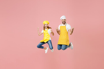 Full length teen fun girl dad father's helper chef cook confectioner baker in yellow apron cap jump...