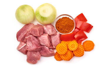 Raw pork pieces, ingredients for goulash, isolated on white background