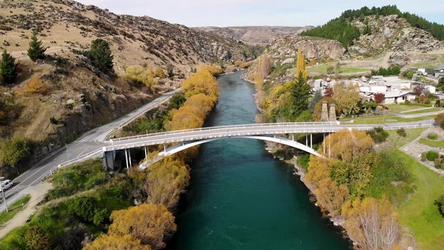 Aerial of white van driving across the bridge to Roxburgh, New Zealand