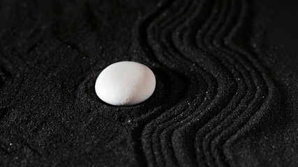 rock garden, white pebbles on black sand, wavy patterns.