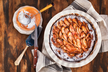 Homemade delicious apple pie, top view, wooden backdrop