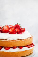 Victoria`s sponge cake, delicious homemade vanilla cake decorated with whipped cream and fresh...