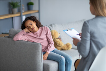 Teenage depression. Psychologist working with upset girl in office, teen thinking about her problems