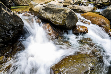Fototapeta premium The stones under the waterfall, close-up waterfall as background.