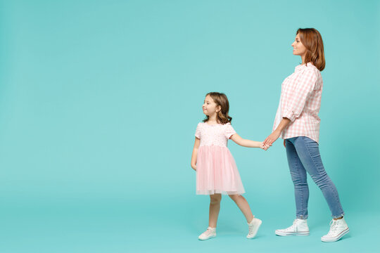 Full Length Woman In Pink Clothes Have Fun With Child Baby Girl 5-6 Years Old. Mommy Little Kid Daughter Walk Go Step Isolated On Pastel Blue Azure Background Studio. Mother's Day Love Family Concept.