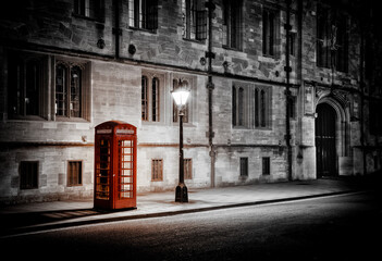 Illuminated Iconic Red British Telephone Box In Oxford City Centre After Dark During Lockdown