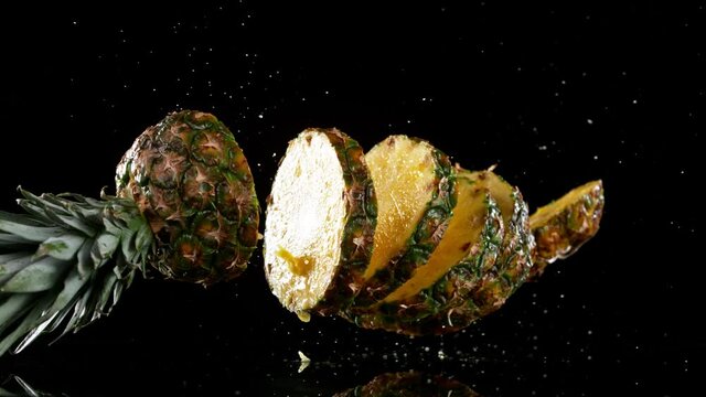 Super slow motion of falling sliced pineapple