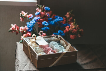 Fototapeta premium Zephyr sweets wrapped in box, decorated with flowers