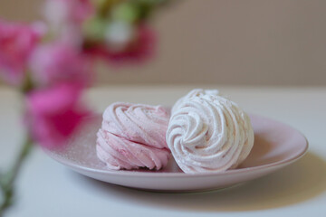 Marshmallows in a pink plate, decorated with blury flower