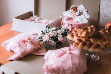 A lot of sweets on the table for the holiday. Pies, muffins, cake, and flowers