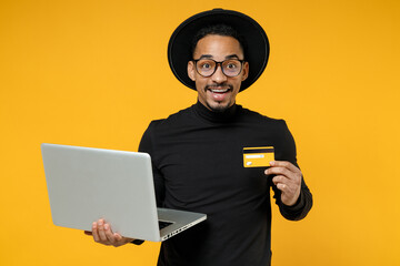 Young freelancer surprised copywriter african man 20s wearing stylish black shirt hat eyeglasses...