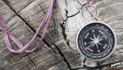 round compass on natural wooden background as symbol of tourism with compass, travel with compass...