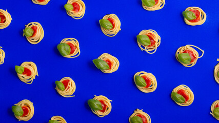 Top view spaghetti napoli with fresh ingredients on a blue background