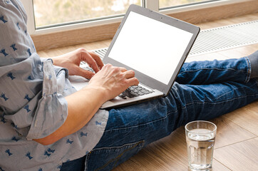 Concept of distance learning, isolation, business, shopping online. Remote working from home. Freelancer workplace in kitchen with laptop