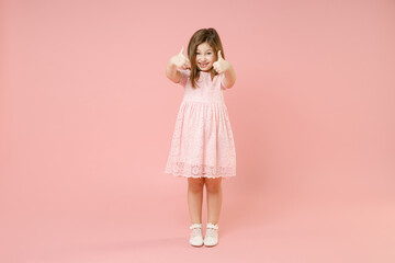 Full length little cute kid girl 5-6 years old wears rosy dress have fun standing isolated on pastel pink background child studio portrait. Mother's Day love family people childhood lifestyle concept.
