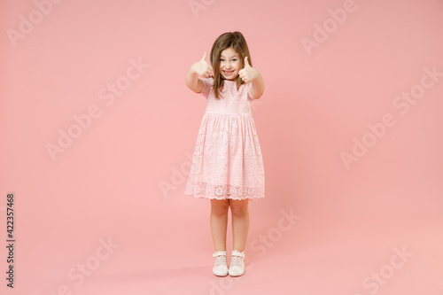 Full length little cute kid girl 5-6 years old wears rosy dress have fun standing isolated on pastel pink background child studio portrait. Mother's Day love family people childhood lifestyle concept.