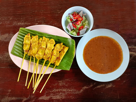 Pork satay with peanut sauce and cocomber salad are very delicious and popular food in Thailand. 