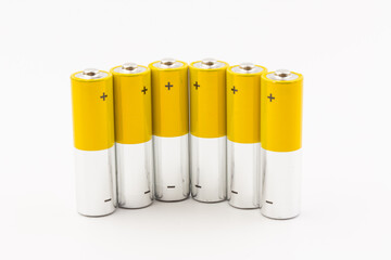Photo of gray-yellow alkaline AA batteries on white background. Recycling of rechargeable NiMH...