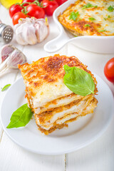 Mediterranean food, Italian traditional lasagna pasta, with bolognese, bechamel and cheese. On white kitchen table background