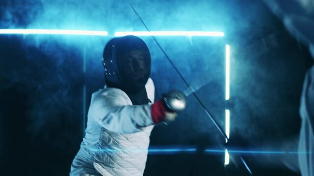 Fencing training session of two athletes in protection wear