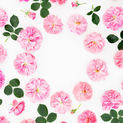 Floral frame of pink roses on white background. Flat lay