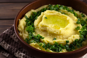 Champ is an Irish dish. Mashed potatoes with green onions. Wooden background.