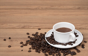 Coffee cup with coffee beans on the wooden background